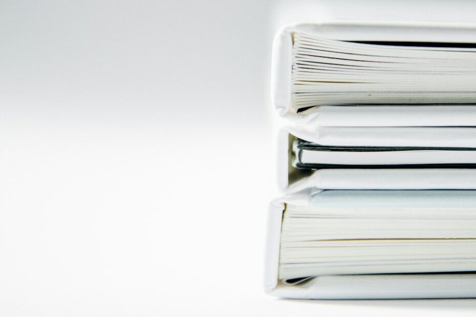 Stack of case file binders, representing changing divorce lawyers during a Virginia case