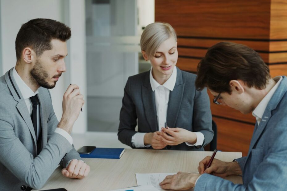 Clients meeting with a lawyer at a table, representing hiring a local divorce lawyer in Roanoke or Salem VA